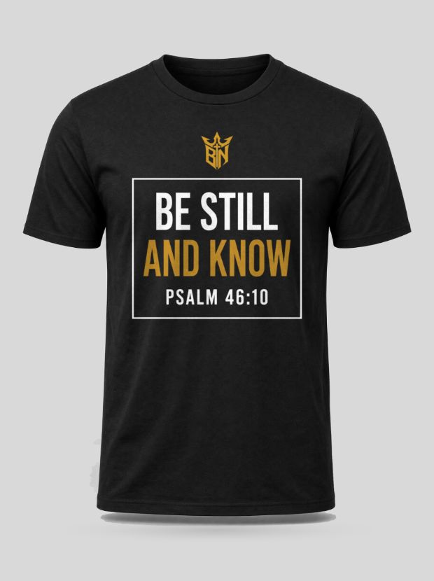 Front view of a black Cotton shirt printed with the Be Still and Know — Psalm 46:10 design.